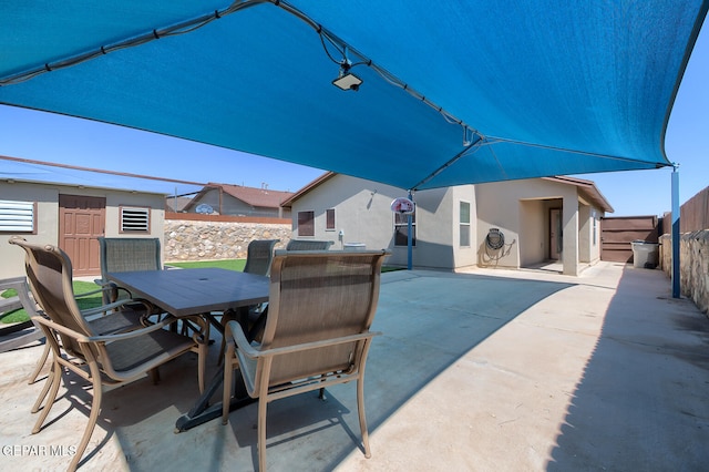 10677 Canyon Sage Dr, El Paso, TX 79924 - view of patio with outdoor dining area and a fenced backyard