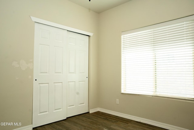 756 Jalynn Grace, Canutillo, TX 79835 - unfurnished bedroom featuring a closet, dark wood-type flooring, and multiple windows