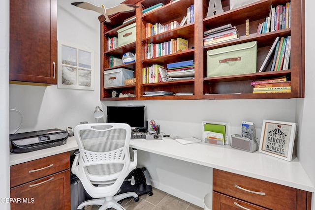 office featuring tile patterned floors and built in study area