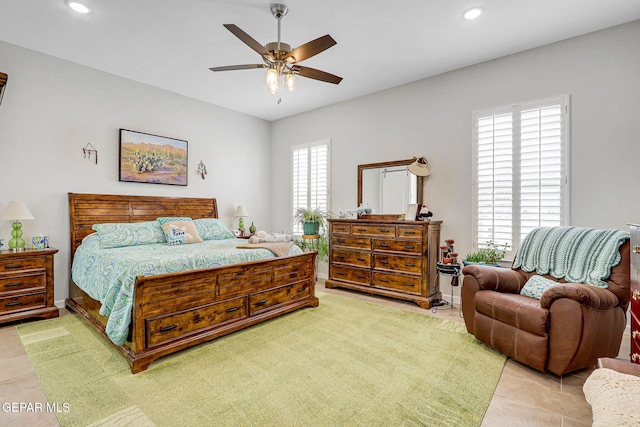 tiled bedroom with ceiling fan and recessed lighting