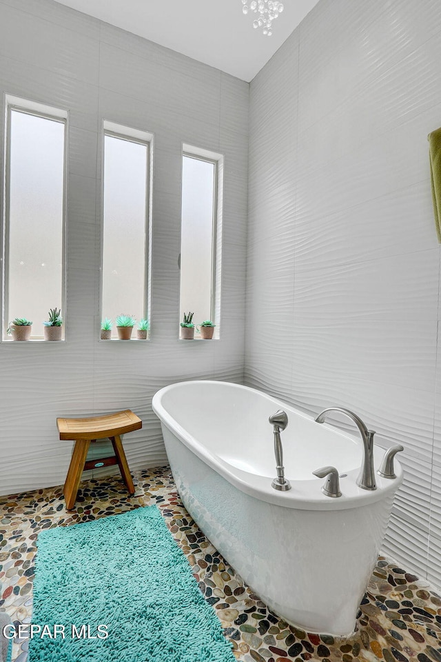 full bathroom with a freestanding bath