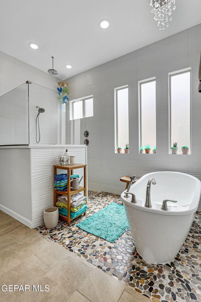 full bath featuring a soaking tub, tile walls, walk in shower, and recessed lighting