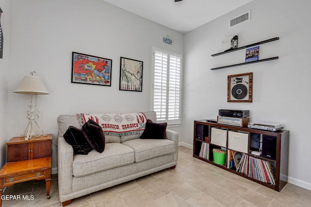 sitting room with baseboards, visible vents, tile patterned flooring, and a healthy amount of sunlight