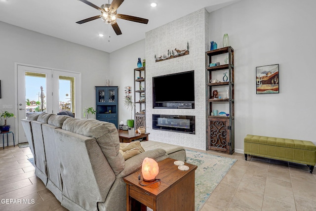 living room with a large fireplace, a ceiling fan, baseboards, and recessed lighting