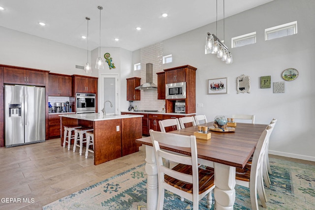 dining area with a high ceiling and recessed lighting