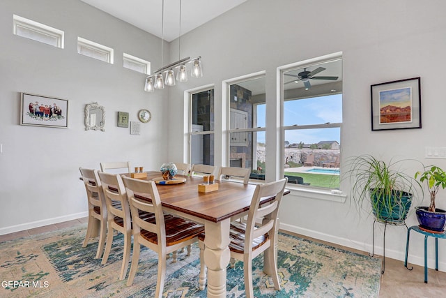 dining area with baseboards and a ceiling fan