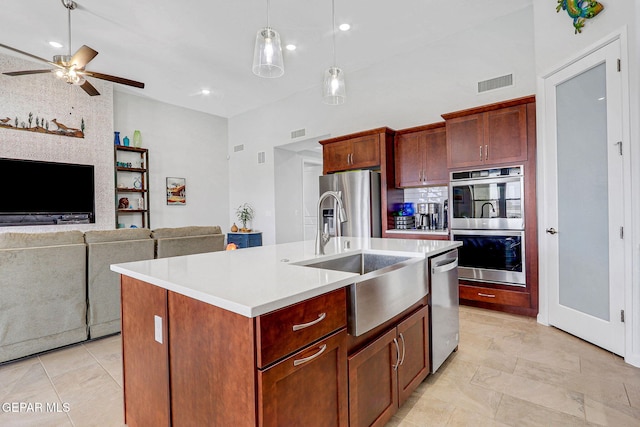 kitchen with a sink, visible vents, a ceiling fan, light countertops, and appliances with stainless steel finishes