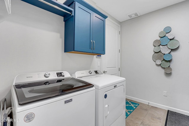 clothes washing area featuring washer and dryer, baseboards, cabinet space, and visible vents