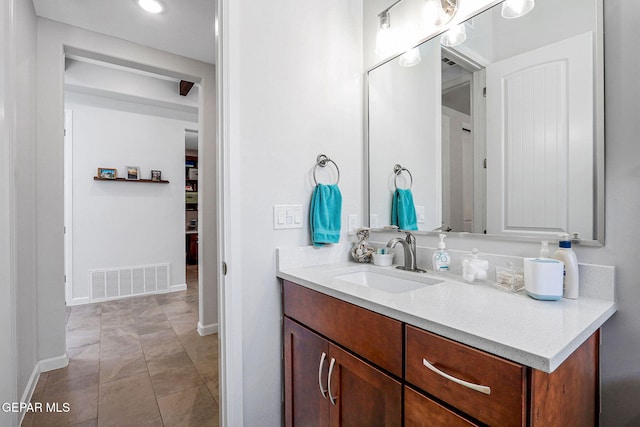 bathroom with baseboards, visible vents, recessed lighting, and vanity
