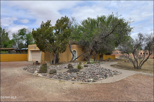 29 Cielo Vis, Anthony, NM 88021 - exterior space featuring stucco siding, an attached garage, and fence