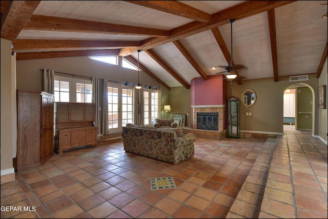 29 Cielo Vis, Anthony, NM 88021 - unfurnished living room featuring vaulted ceiling with beams, visible vents, arched walkways, and ceiling fan