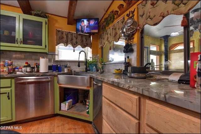 29 Cielo Vis, Anthony, NM 88021 - kitchen with light wood-type flooring, decorative backsplash, stainless steel dishwasher, a sink, and green cabinetry