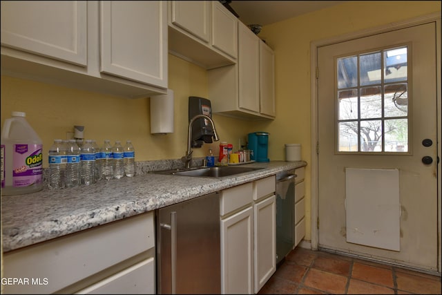 29 Cielo Vis, Anthony, NM 88021 - kitchen with white cabinets, light countertops, a sink, and stainless steel dishwasher