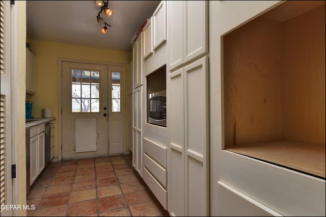 29 Cielo Vis, Anthony, NM 88021 - kitchen featuring light countertops, stone tile floors, dishwasher, white cabinets, and track lighting