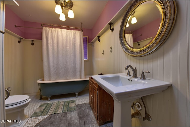 29 Cielo Vis, Anthony, NM 88021 - bathroom featuring shower / bath combination with curtain, toilet, a sink, and wood finished floors