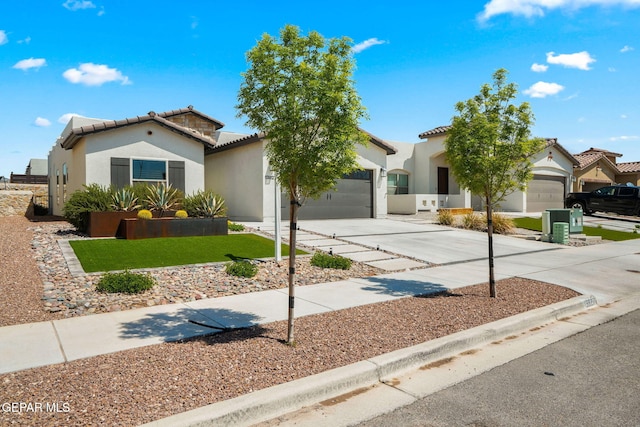 view of front facade with an attached garage, concrete driveway, stucco siding, and a tile roof