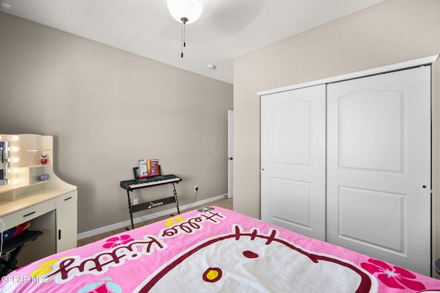 bedroom featuring a closet, carpet, and baseboards