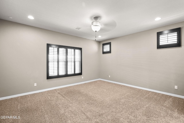 carpeted spare room featuring ceiling fan, baseboards, visible vents, and recessed lighting