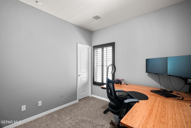 carpeted office featuring baseboards and visible vents