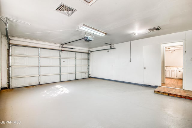 garage with a garage door opener and visible vents
