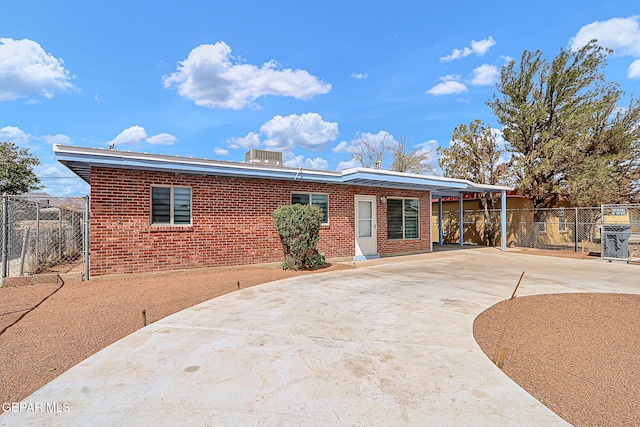 single story home featuring brick siding, driveway, and fence