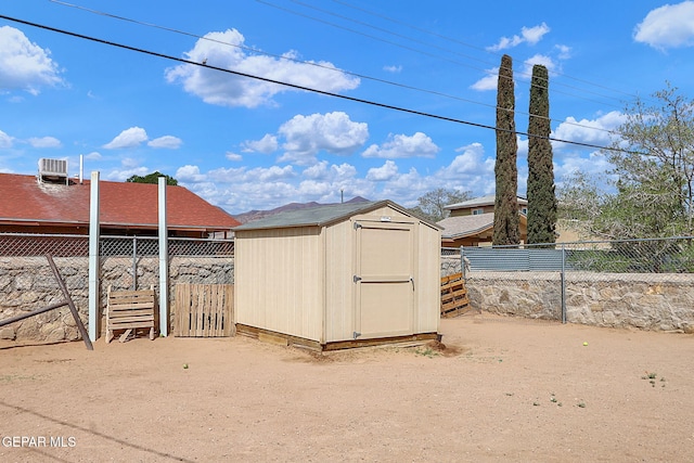 view of shed with fence