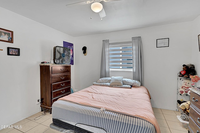bedroom featuring baseboards, a ceiling fan, and light tile patterned floors