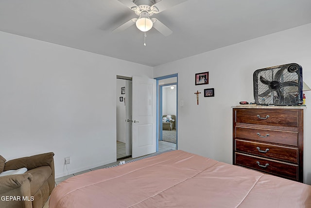 tiled bedroom featuring a ceiling fan