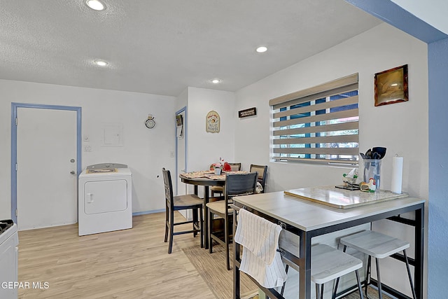 dining space featuring light wood-style flooring, recessed lighting, washer / dryer, and a textured ceiling