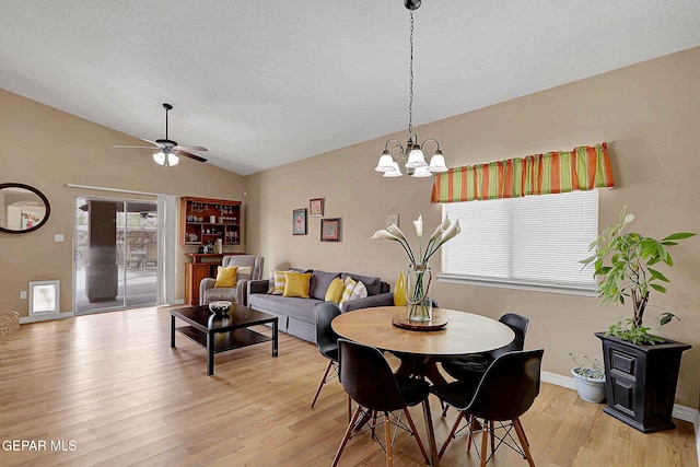7101 Luz De Sol Dr, El Paso, TX 79912 - dining room featuring baseboards, a textured ceiling, lofted ceiling, light wood finished floors, and ceiling fan with notable chandelier