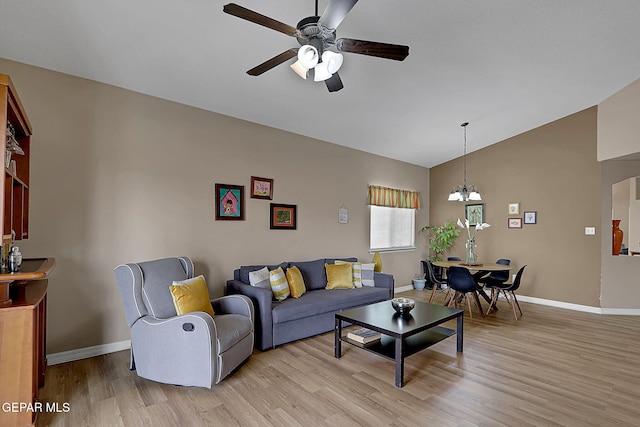 7101 Luz De Sol Dr, El Paso, TX 79912 - living area with light wood-style flooring, lofted ceiling, baseboards, and ceiling fan with notable chandelier
