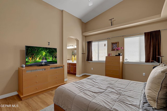 7101 Luz De Sol Dr, El Paso, TX 79912 - bedroom featuring baseboards, ensuite bath, high vaulted ceiling, arched walkways, and light wood finished floors