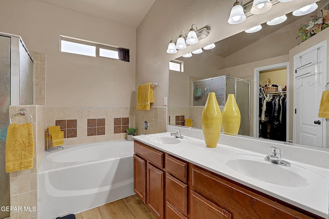 7101 Luz De Sol Dr, El Paso, TX 79912 - bathroom with double vanity, a bath, a sink, and a stall shower