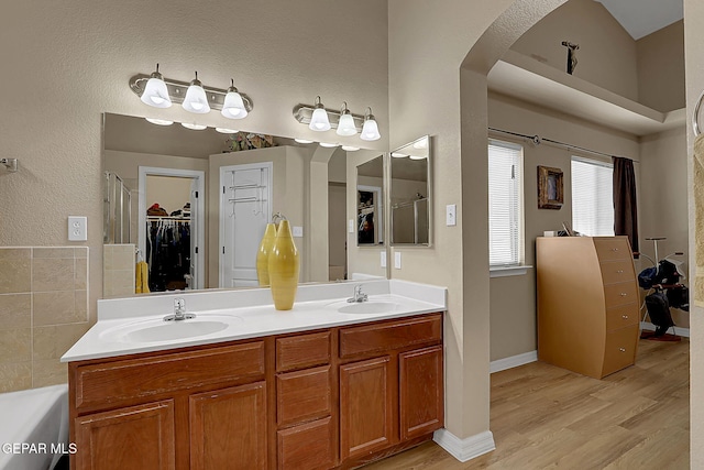 7101 Luz De Sol Dr, El Paso, TX 79912 - full bath featuring a sink, a walk in closet, double vanity, and wood finished floors