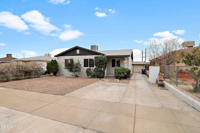 view of front of home featuring stucco siding and fence