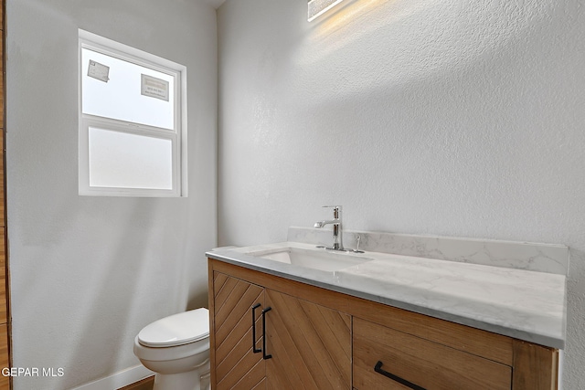 bathroom featuring toilet and vanity