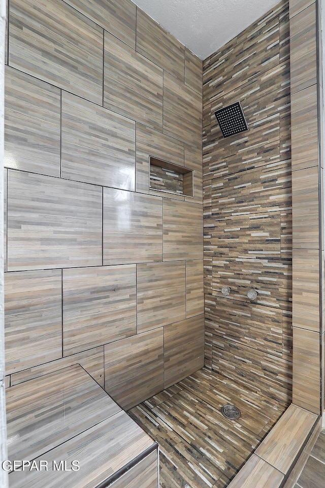 full bath with a tile shower