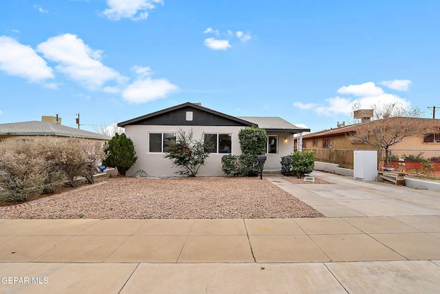 single story home featuring stucco siding and fence