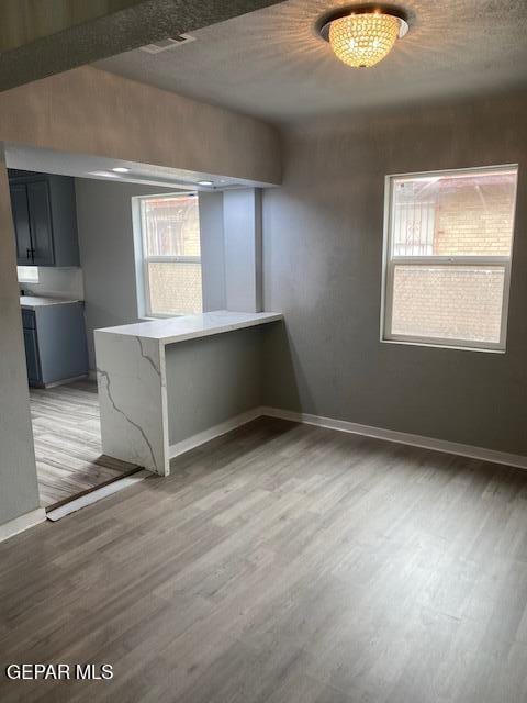 spare room with baseboards, visible vents, and light wood-style flooring