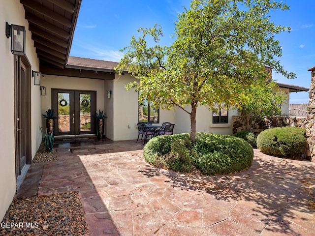 exterior space with french doors, stucco siding, and a patio area