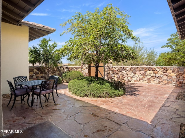 view of patio / terrace featuring fence and outdoor dining area