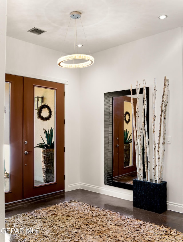 foyer featuring baseboards, recessed lighting, a chandelier, and visible vents