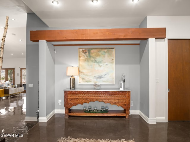 hallway with recessed lighting, baseboards, and finished concrete floors