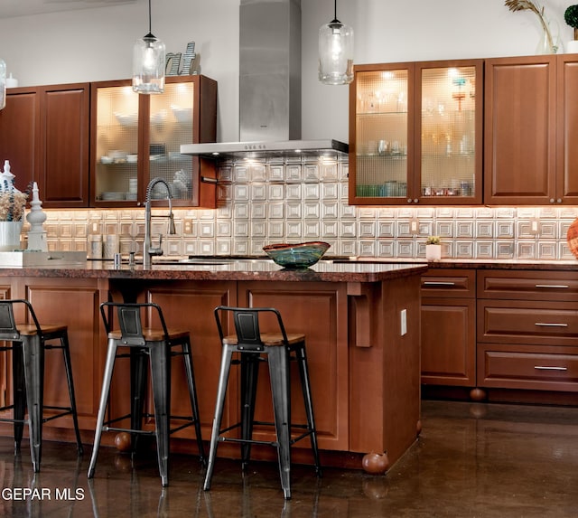 bar with a sink, decorative backsplash, ventilation hood, and decorative light fixtures