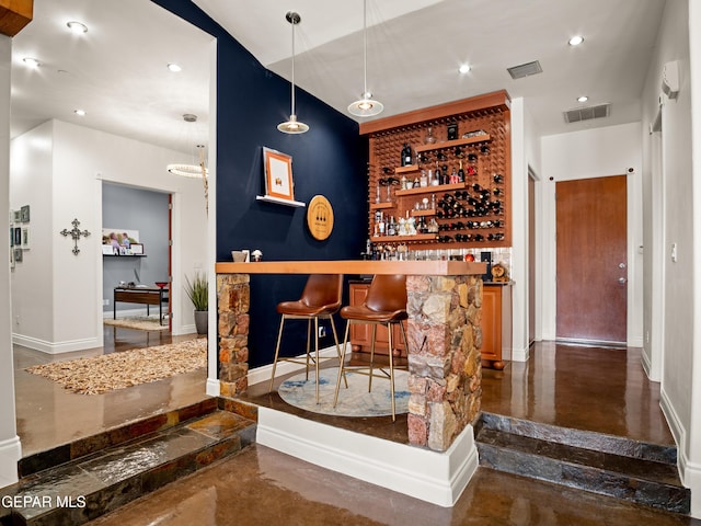 bar with visible vents, pendant lighting, baseboards, a bar, and recessed lighting