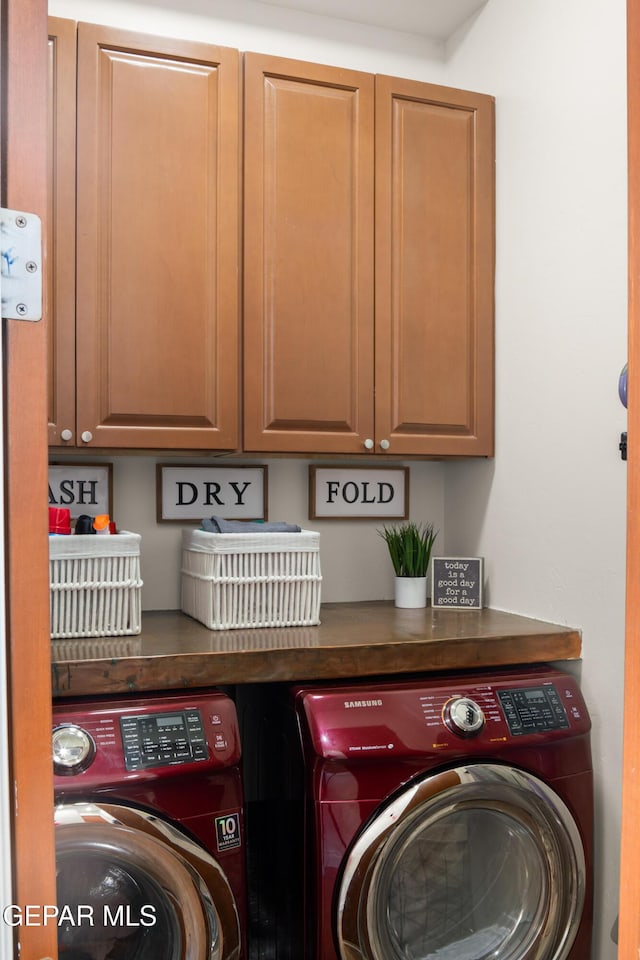 laundry area with cabinet space and separate washer and dryer