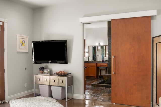 interior space featuring baseboards and ensuite bath