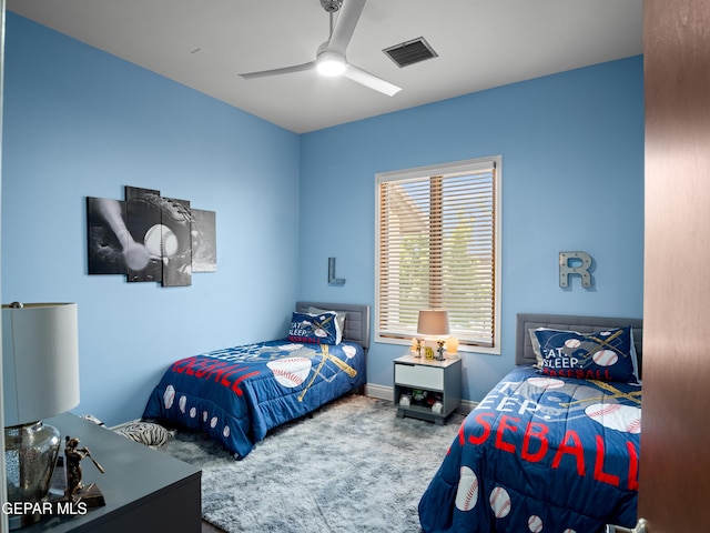 carpeted bedroom featuring visible vents, a ceiling fan, and baseboards