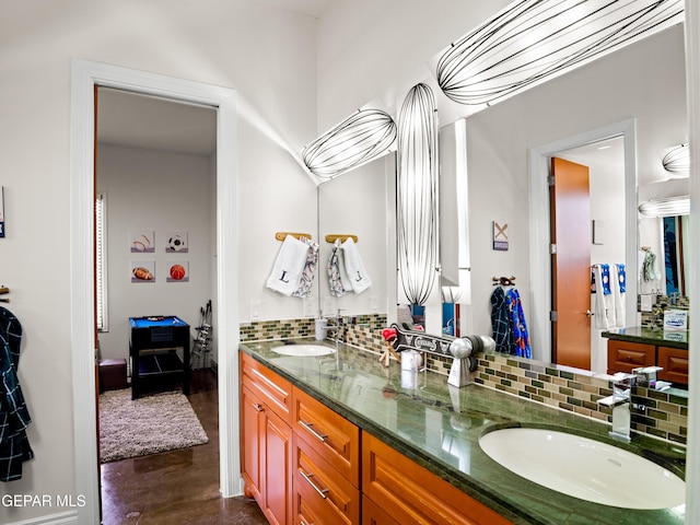 bathroom featuring double vanity, decorative backsplash, a sink, and concrete floors