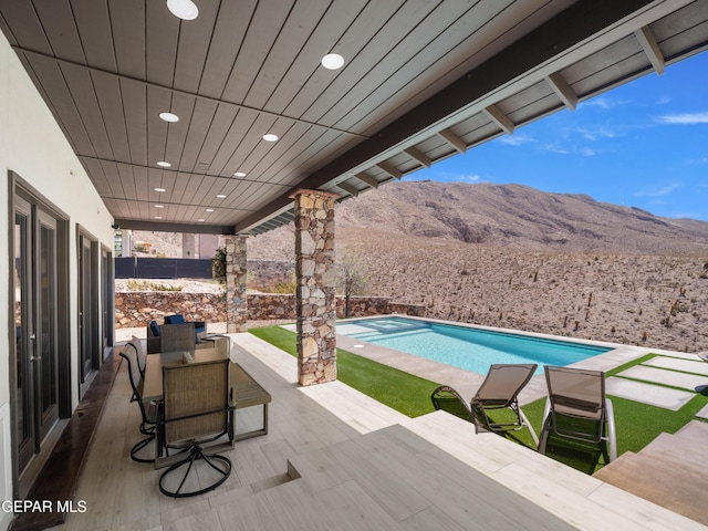 view of patio featuring a mountain view and an outdoor pool